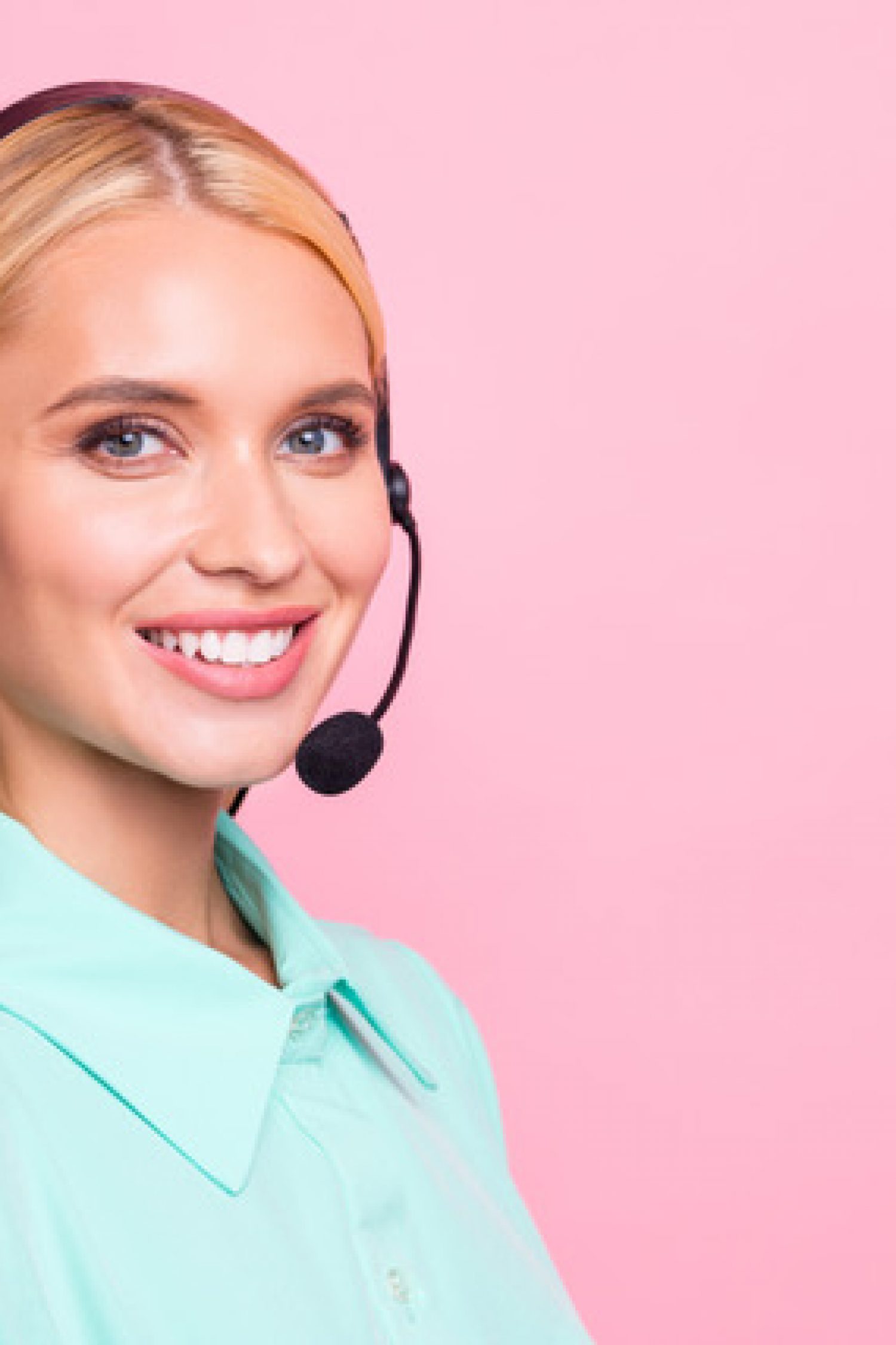 Close up turned photo of cheerful professional looking with toothy, smile wearing mint color shirt isolated over pink background